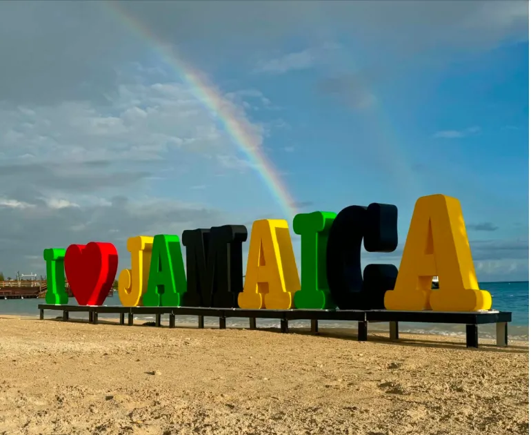 I love Jamaica sign in front of double rainbow